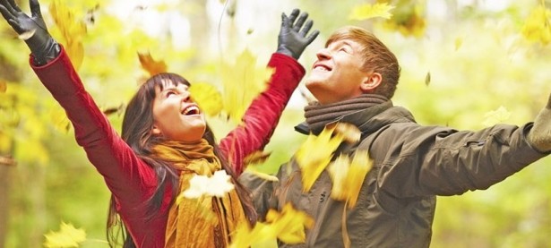 Autumn - Happy couple enjoying the falling leaves
